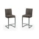 Two brown bar stools with pleated seats on a white background