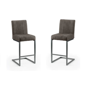 Two brown bar stools with pleated seats on a white background