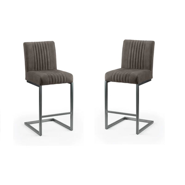 Two brown bar stools with pleated seats on a white background