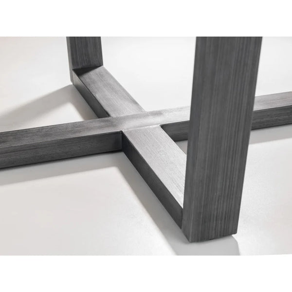 Close-up of a modern furniture leg with cross-brace design on a white background