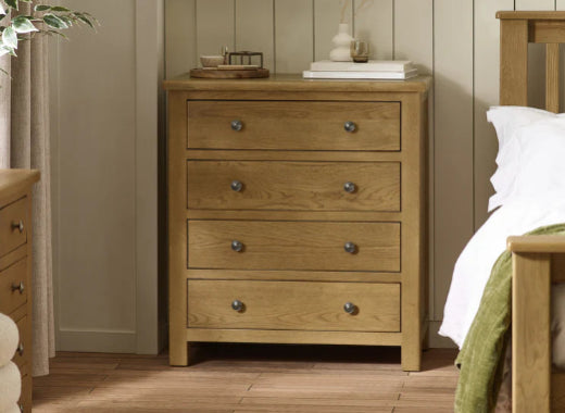 Wooden dresser with multiple drawers in a bedroom setting.