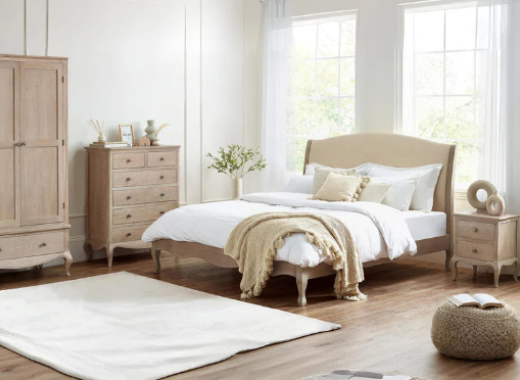 Neatly arranged bedroom with wooden furniture and white bedding