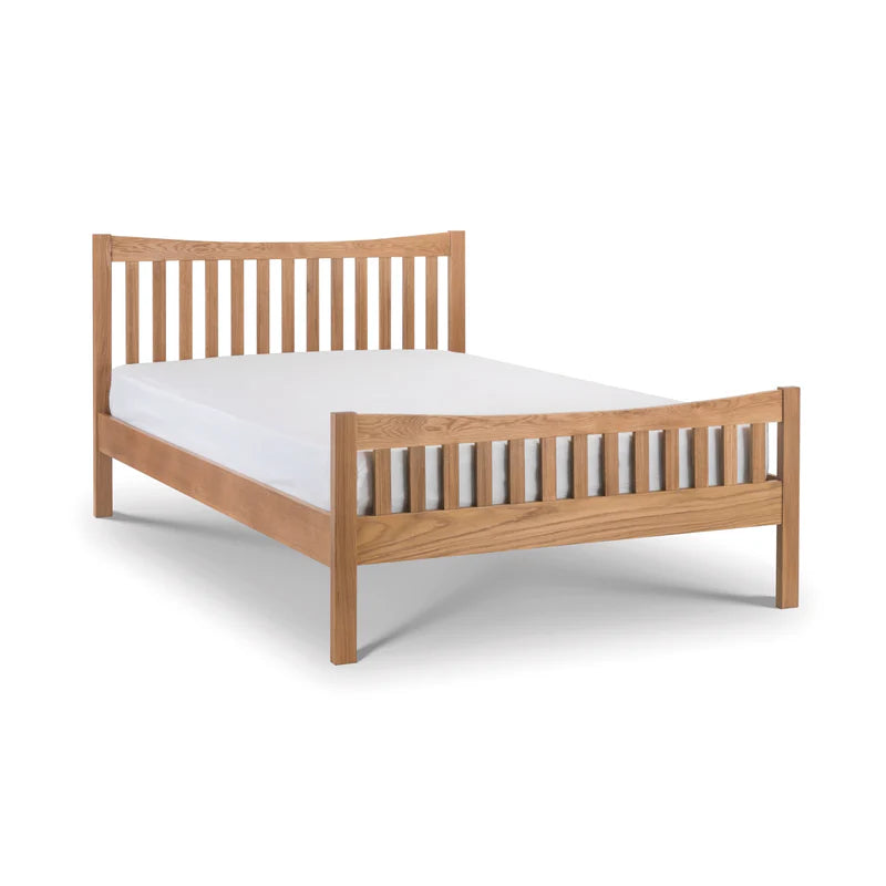 Wooden bed frame with white mattress on a white background