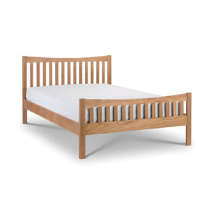 Wooden bed frame with white mattress on a white background