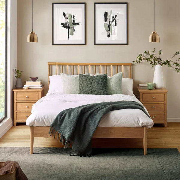 Bedroom with wooden bed, nightstands, and abstract art on the wall.