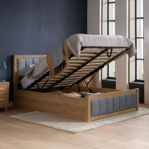 Wooden bed with storage compartment in a bedroom setting