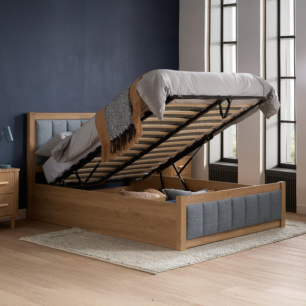 Wooden bed with storage compartment in a bedroom setting