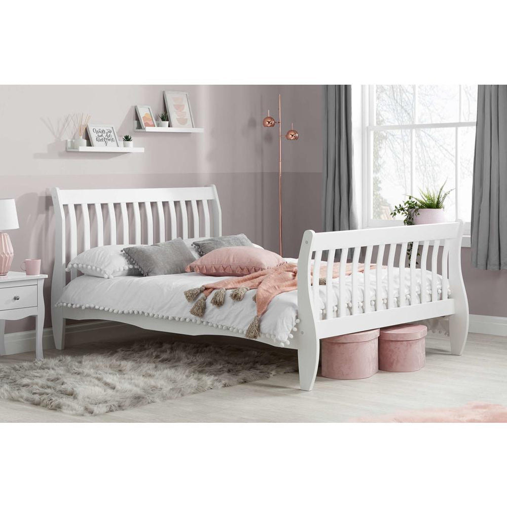 White bed frame with mattress on white background