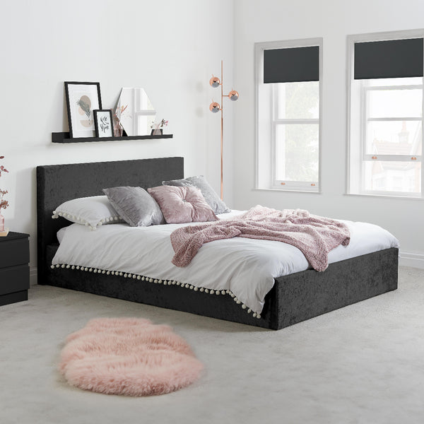 Bedroom with a black upholstered bed, white bedding, and pink accents.