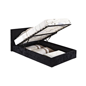 Black upholstered bed with open storage compartment on a white background