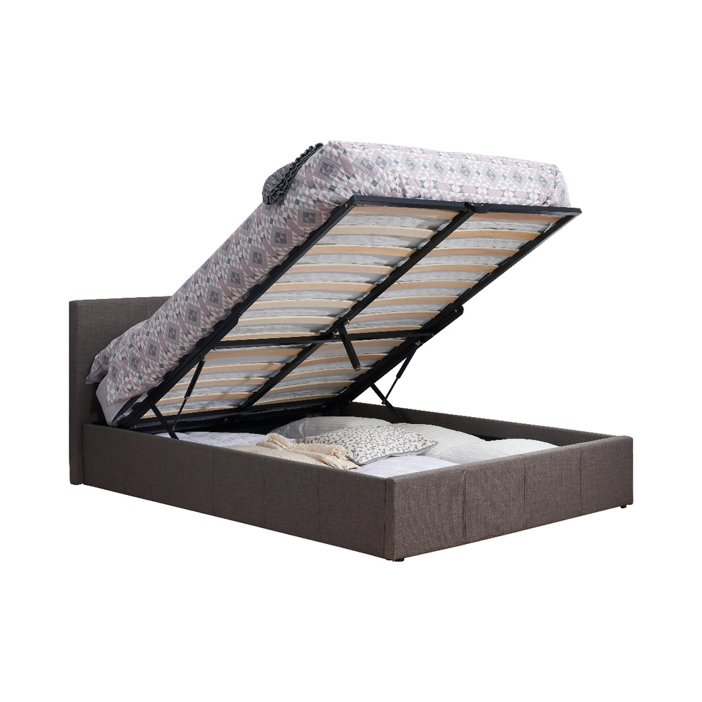 Grey upholstered bed with open storage compartment on a white background
