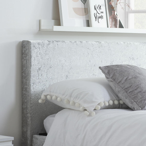 Gray textured headboard with white bedding and gray pillows in a bedroom setting.