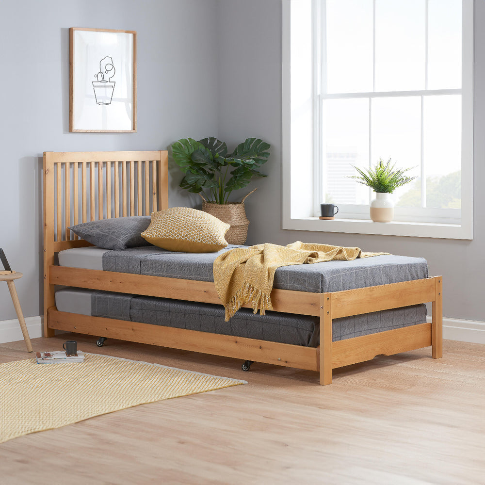 Wooden bed frame with mattress on a white background