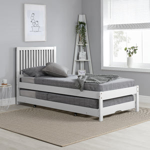 White bed frame with gray mattress in a room with a window and decorative items.