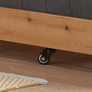 Wooden bed frame with wheels on a wooden floor