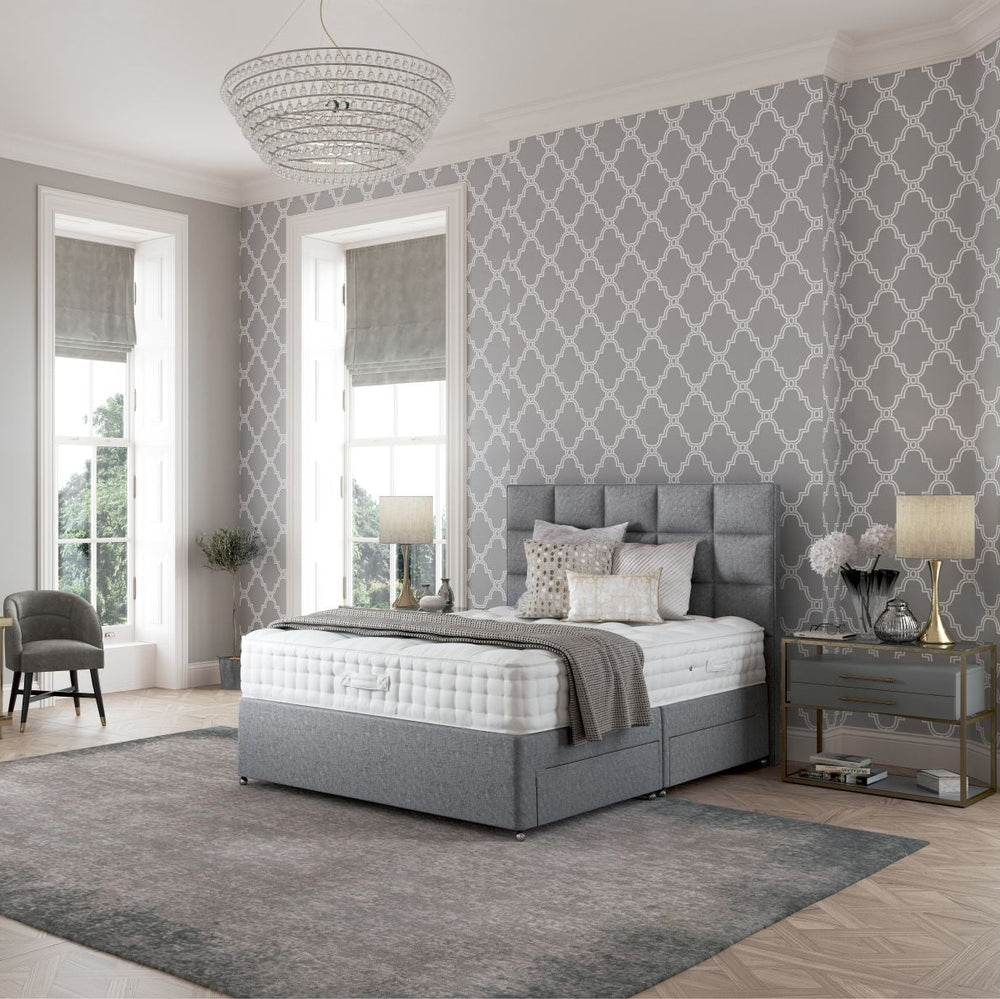 Gray upholstered bed with white mattress on a white background