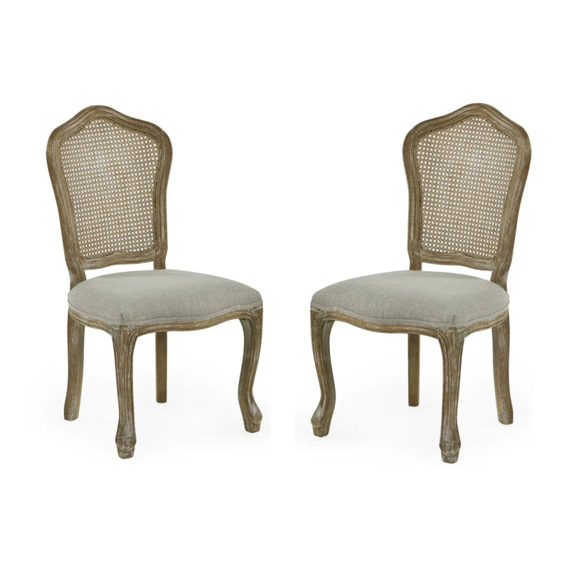 Two wooden chairs with caned backrests and upholstered seats on a white background