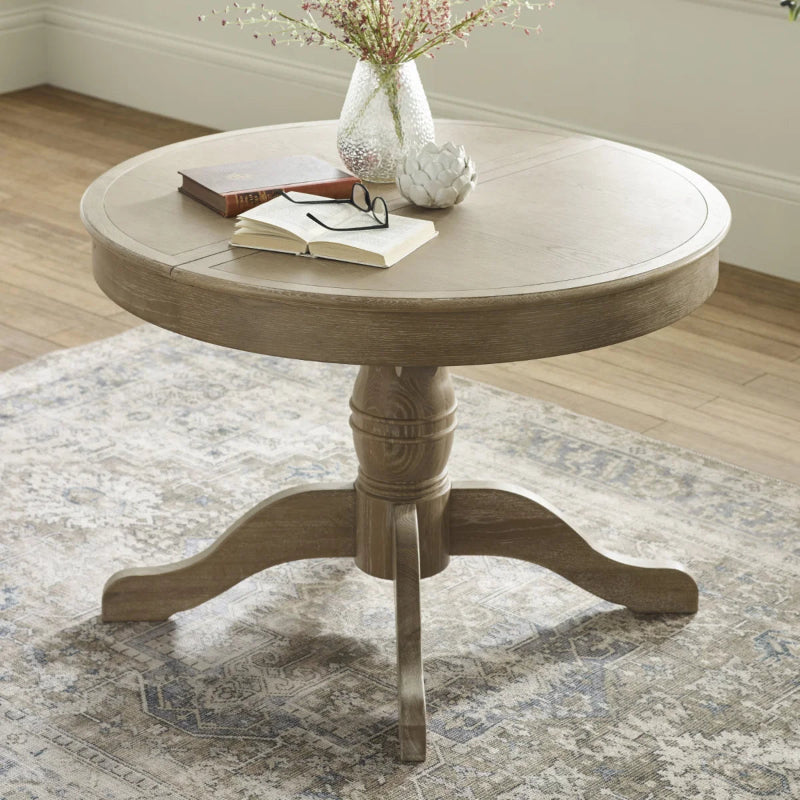 Round wooden table with a pedestal base on a white background
