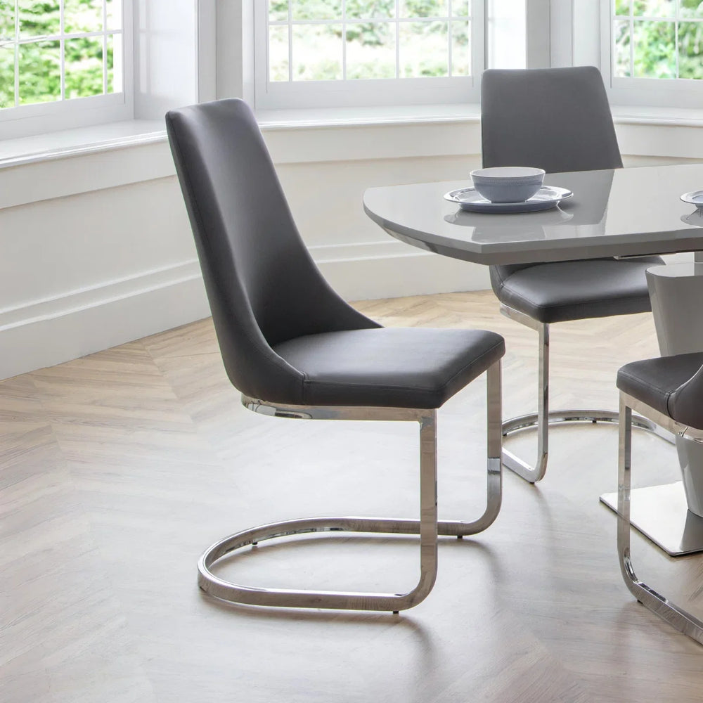 Two gray chairs with chrome frames on a white background