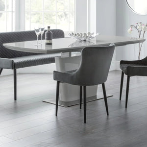 Modern dining room with a gray table and chairs in a bright room.