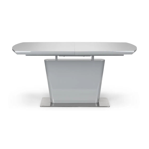 White extending dining table on a white background