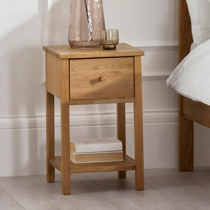 Wooden side table with a drawer on a white background