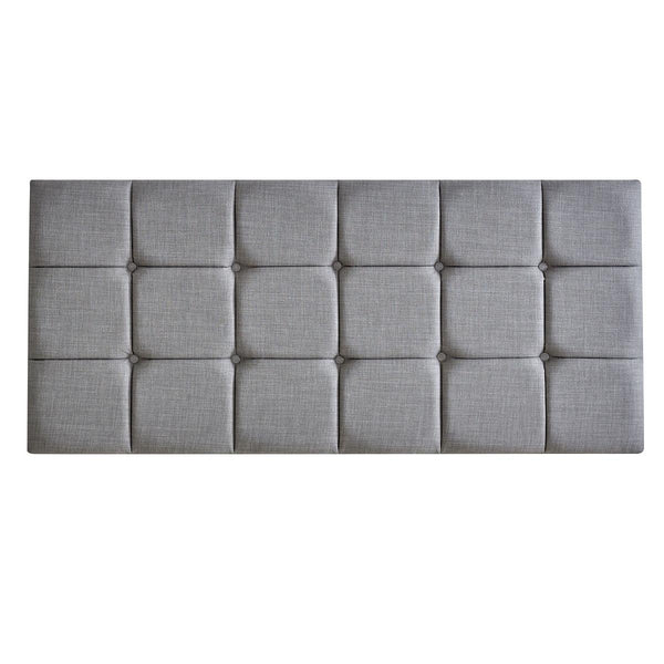 Gray tufted headboard on a white background