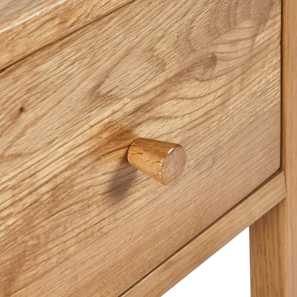 Wooden drawer with a round knob on a wooden cabinet.