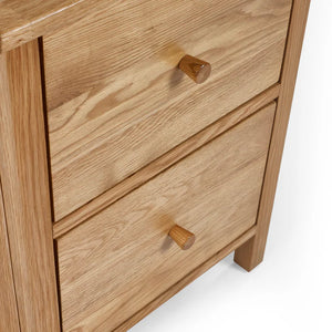 Wooden drawer unit with two drawers and wooden handles on a white background