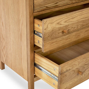 Wooden dresser with open drawers on a white background