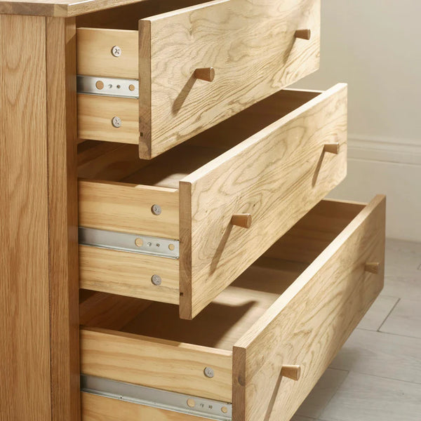 Oak chest of drawers with open drawers
