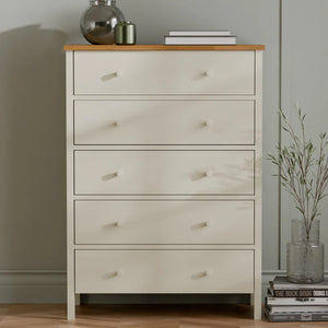 White dresser with wooden top against a neutral wall