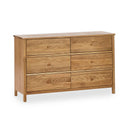 Wooden dresser with six drawers on a white background