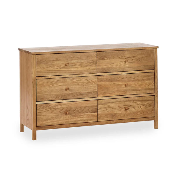 Wooden dresser with six drawers on a white background