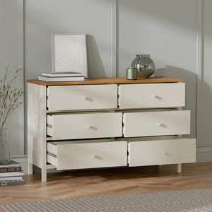 Wooden dresser with six drawers in a room setting