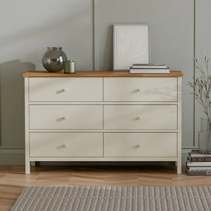 White dresser with wooden top in a room setting