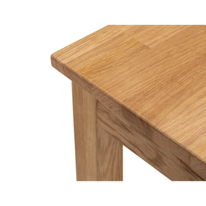 Close-up of a wooden table corner on a white background