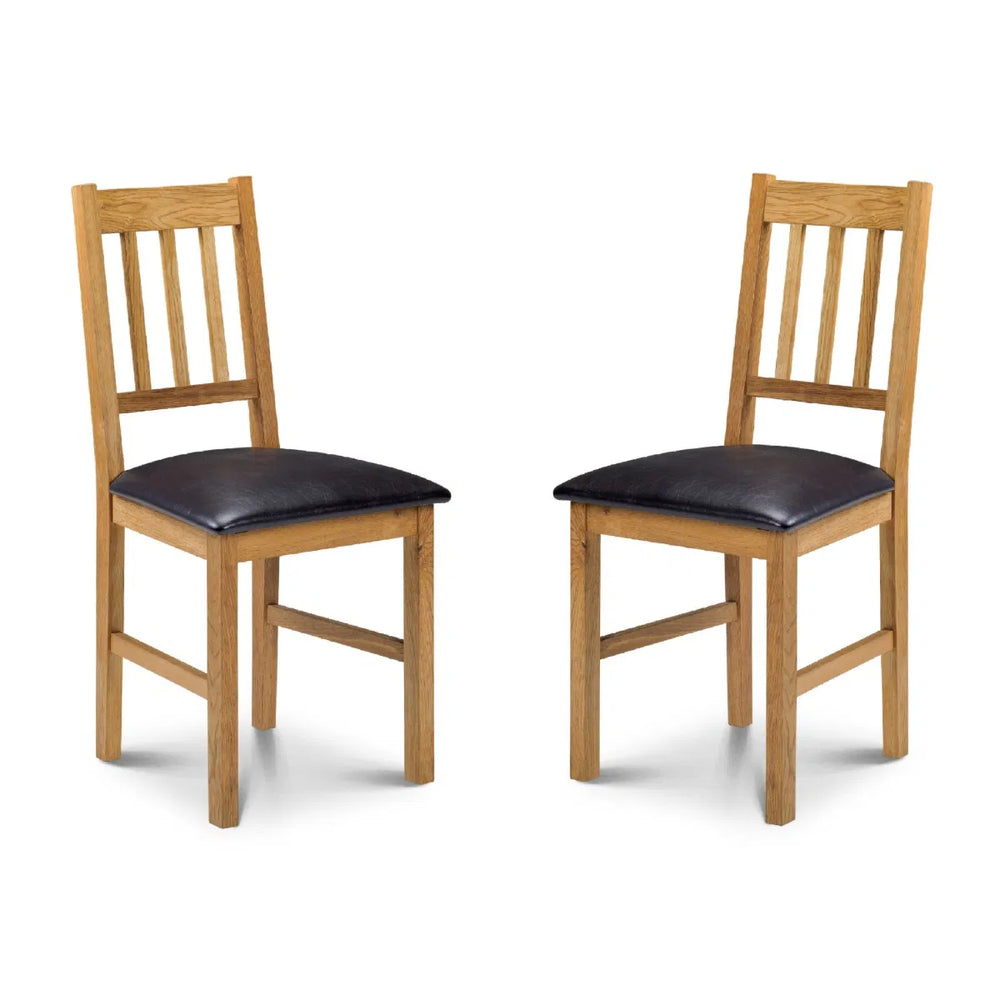Two wooden chairs with black cushioned seats on a white background