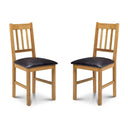 Two wooden chairs with black cushioned seats on a white background