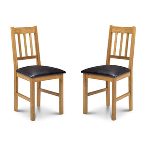 Two wooden chairs with black cushioned seats on a white background