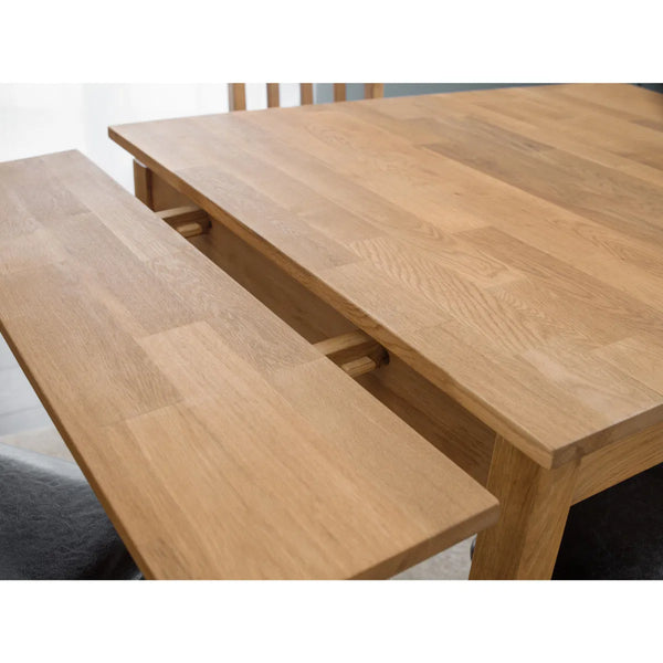 Wooden dining table with benches on a white background