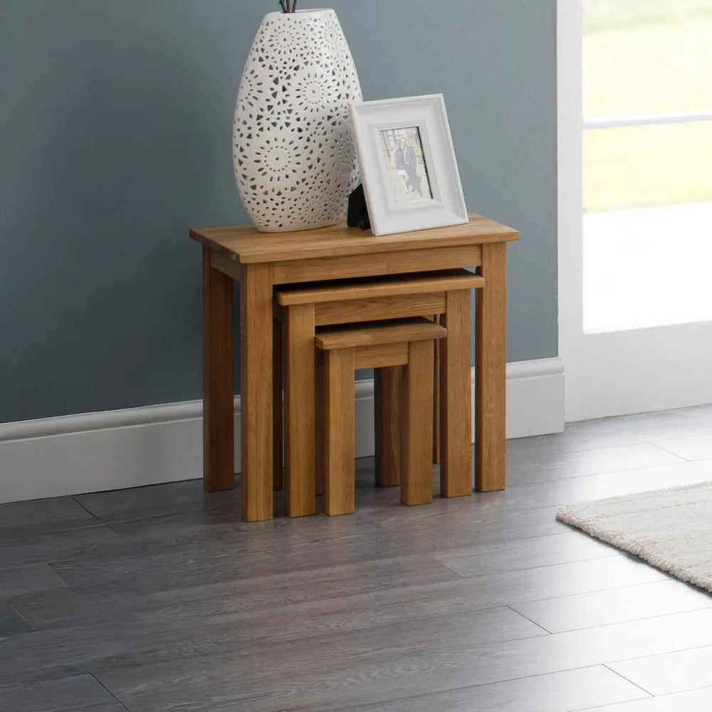 Set of three wooden nesting tables on a white background