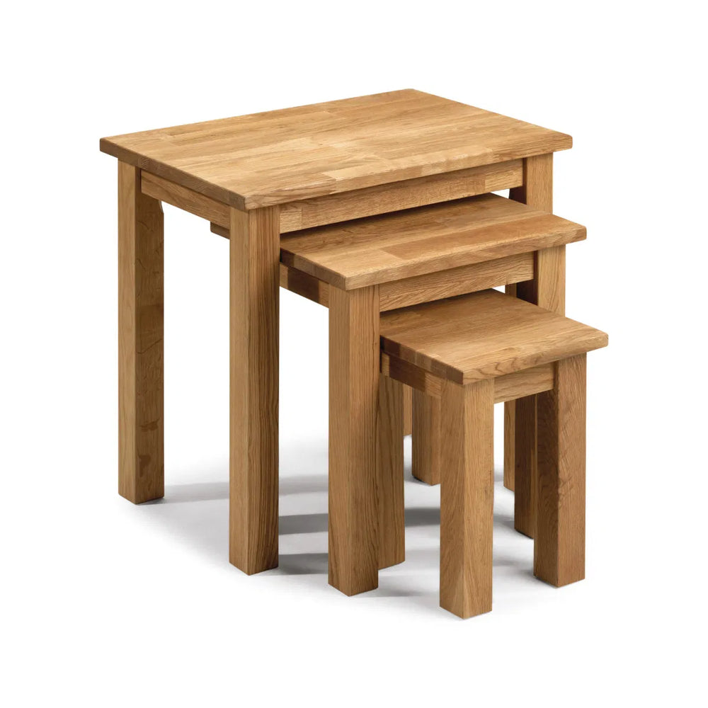 Set of three wooden nesting tables on a white background