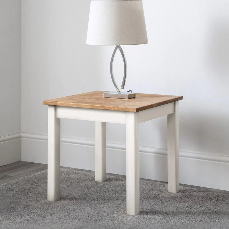 Small table with wooden top and white base on a white background