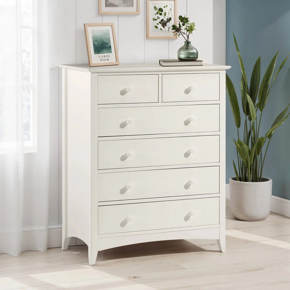 White dresser with multiple drawers on a white background
