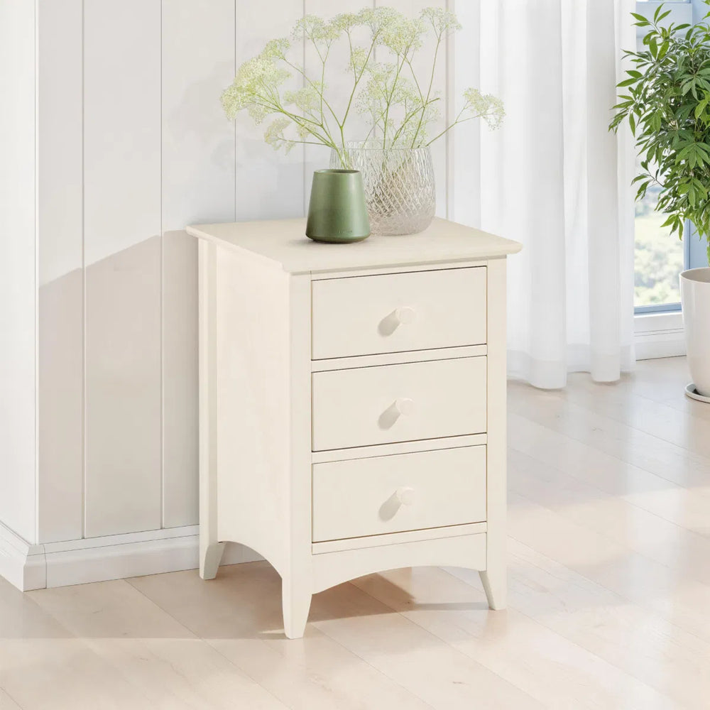 White three-drawer nightstand on a white background