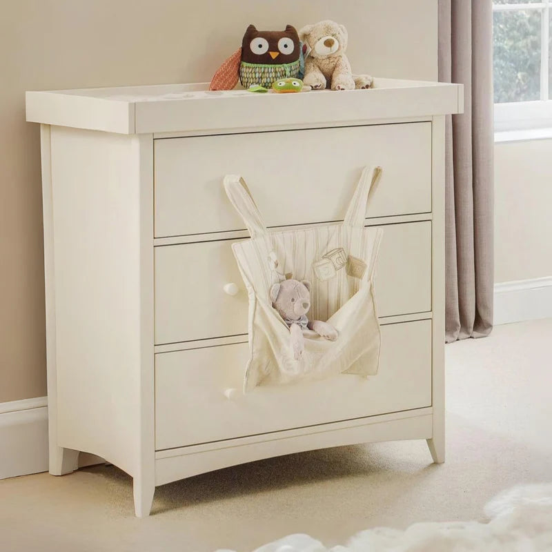 White changing unit dresser with three drawers on a white background