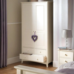 White wardrobe with a heart-shaped decoration in a bedroom setting.