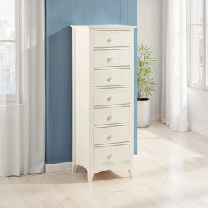 White dresser with multiple drawers in a room with blue walls and white curtains.