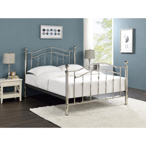 Silver metal bed frame with white bedding in a bedroom setting.